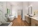 Modern bathroom featuring a glass shower, soaking tub, and double sink vanity with quartz countertops at 492 Mary Hill Ln, Douglasville, GA 30134