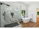 Bathroom showcasing a glass shower with black fixtures and a soaking tub at 492 Mary Hill Ln, Douglasville, GA 30134