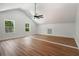 Large bedroom with vaulted ceiling, hardwood floors, and windows overlooking the lush outdoors at 492 Mary Hill Ln, Douglasville, GA 30134