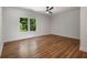 Spacious bedroom showcasing hardwood floors, two windows, and a ceiling fan at 492 Mary Hill Ln, Douglasville, GA 30134