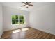 Cozy bedroom with natural light, gleaming hardwood floors and a ceiling fan at 492 Mary Hill Ln, Douglasville, GA 30134