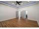 Large bedroom with hardwood floors, recessed lighting, tray ceilings, and double doors at 492 Mary Hill Ln, Douglasville, GA 30134