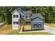Charming two-story home with a blue and white exterior, complemented by a wooden porch and lush greenery at 492 Mary Hill Ln, Douglasville, GA 30134