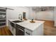 Kitchen island featuring stainless steel sink, dishwasher, and elegant marble countertops at 492 Mary Hill Ln, Douglasville, GA 30134