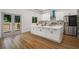 Bright kitchen with white cabinets, stainless steel appliances, a large island, and hardwood floors at 492 Mary Hill Ln, Douglasville, GA 30134
