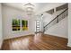 Bright living room featuring wood floors, modern lighting, staircase and window views at 492 Mary Hill Ln, Douglasville, GA 30134