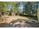 Spacious backyard with a wood fence and mature trees offering shade and privacy at 6149 Josephine Rd, Atlanta, GA 30340