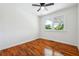 Bright bedroom featuring hardwood floors, a ceiling fan, and natural light from the window at 6149 Josephine Rd, Atlanta, GA 30340