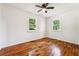 Cozy bedroom with hardwood flooring, fan, and dual windows offering an airy atmosphere at 6149 Josephine Rd, Atlanta, GA 30340