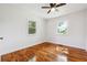Inviting bedroom with hardwood floors, a ceiling fan, and two bright windows at 6149 Josephine Rd, Atlanta, GA 30340
