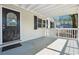 Inviting covered front porch featuring white railings and a decorative front door at 6149 Josephine Rd, Atlanta, GA 30340