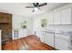 Bright eat-in kitchen featuring white cabinets, granite countertops, and hardwood floors at 6149 Josephine Rd, Atlanta, GA 30340