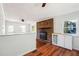 Open living area with hardwood floors, a brick fireplace, and white paneled walls at 6149 Josephine Rd, Atlanta, GA 30340