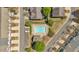 Aerial view of a neighborhood swimming pool surrounded by trees and townhomes at 706 Woodland Pl, Woodstock, GA 30188