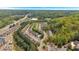 Aerial view of the townhome community showing a pool, wooded areas, and highway access at 706 Woodland Pl, Woodstock, GA 30188