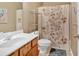 Bathroom featuring wooden vanity, floral shower curtain and towel rack at 706 Woodland Pl, Woodstock, GA 30188