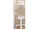 Lovely pedestal sink with vanity and lighting at 706 Woodland Pl, Woodstock, GA 30188