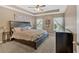 The primary bedroom has a trey ceiling and 2 windows offering an abundance of natural light at 706 Woodland Pl, Woodstock, GA 30188