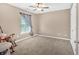 Bedroom featuring an overhead fan, large window and rocking chair at 706 Woodland Pl, Woodstock, GA 30188