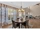 Open dining room has wood floors, light fixture and ample sunlight for a warm and inviting feel at 706 Woodland Pl, Woodstock, GA 30188
