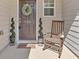 Inviting front porch with rocking chair and spiral topiaries at 706 Woodland Pl, Woodstock, GA 30188