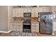 Charming kitchen featuring stainless steel appliances and ample counter space at 706 Woodland Pl, Woodstock, GA 30188