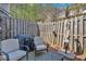 Outdoor patio with chairs, a grill and a wooden fence at 706 Woodland Pl, Woodstock, GA 30188