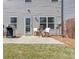 Back patio area with grill, outdoor seating with pillows, and a door leading inside at 1546 Silvaner Nw Ave # 20, Kennesaw, GA 30152