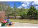Beautiful backyard with flowerpots on a table, a fenced-in yard, green grass, and trees at 1546 Silvaner Nw Ave # 20, Kennesaw, GA 30152