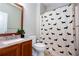 Bathroom featuring a patterned shower curtain and a vanity with a granite countertop at 1546 Silvaner Nw Ave # 20, Kennesaw, GA 30152