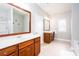 Bright bathroom features double vanity with wood cabinets, granite countertops, and large framed mirrors at 1546 Silvaner Nw Ave # 20, Kennesaw, GA 30152