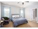 Bedroom with bed, chair, side table and two windows at 1546 Silvaner Nw Ave # 20, Kennesaw, GA 30152