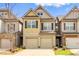Charming townhome featuring a two-car garage and neutral-toned exterior at 1546 Silvaner Nw Ave # 20, Kennesaw, GA 30152