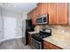 Well-equipped kitchen with stone backsplash, stainless steel appliances, and granite counters at 1546 Silvaner Nw Ave # 20, Kennesaw, GA 30152