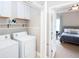 Laundry room with white washer and dryer, shelves, and doorway to bedroom at 1546 Silvaner Nw Ave # 20, Kennesaw, GA 30152