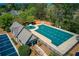 Aerial view of a large community pool and clubhouse surrounded by lush trees and a parking lot at 1546 Silvaner Nw Ave # 20, Kennesaw, GA 30152