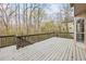 Large deck with gray railing overlooks serene wooded area, perfect for relaxation at 300 Radner Run, Lawrenceville, GA 30043