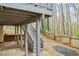 Backyard beneath deck has stone pavers, stairs to deck and privacy fence at 300 Radner Run, Lawrenceville, GA 30043