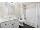 Bathroom featuring a vanity with storage and a shower-tub combo with white tile surround at 300 Radner Run, Lawrenceville, GA 30043