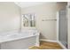 Bathroom features a white tiled soaking tub and walk in shower at 300 Radner Run, Lawrenceville, GA 30043