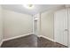 Bedroom with warm neutral paint, new flooring, and a door for easy access to other parts of the home at 300 Radner Run, Lawrenceville, GA 30043