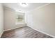 This room has neutral walls, new floors, natural light from a window, and a double-door closet for storage at 300 Radner Run, Lawrenceville, GA 30043