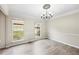Dining room featuring crown molding, chandelier, natural lighting, and wood-style flooring at 300 Radner Run, Lawrenceville, GA 30043
