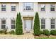 Close-up of the home entrance with mature shrubbery and stone walkway at 300 Radner Run, Lawrenceville, GA 30043