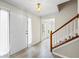 Inviting entryway with light wood floors, a white front door, and staircase leading to the upper level at 300 Radner Run, Lawrenceville, GA 30043