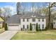 Charming two-story home featuring a manicured front lawn and attached two-car garage at 300 Radner Run, Lawrenceville, GA 30043