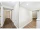 Hallway featuring neutral walls and a mix of wood-look and tile flooring leading to various rooms at 300 Radner Run, Lawrenceville, GA 30043