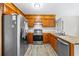 Traditional kitchen with stainless steel appliances, wood cabinets, butcher block countertops, and white tile backsplash at 300 Radner Run, Lawrenceville, GA 30043