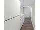 This kitchenette offers white cabinets, marble counters, and stainless steel appliances along a hallway at 300 Radner Run, Lawrenceville, GA 30043
