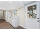 This kitchenette offers white cabinets, marble counters, and stainless steel appliances with a door that leads outside at 300 Radner Run, Lawrenceville, GA 30043